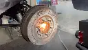 surface-rust-being-removed-from-a-brake-drum-with-laser-cleaning-machine.webp